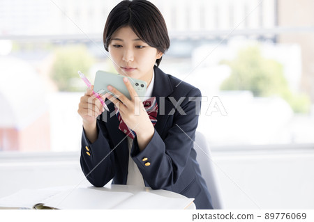 Student high school girl studying on a tablet Student high school girl studying on a tablet 89776069