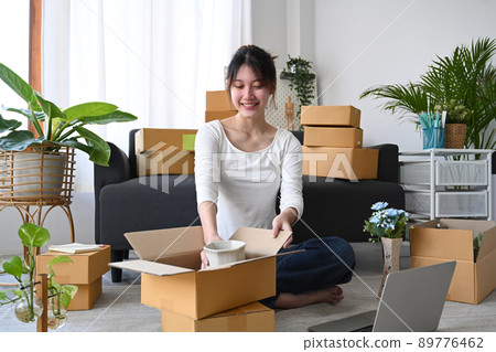 Young start up small business entrepreneur preparing parcel boxes for delivery 89776462