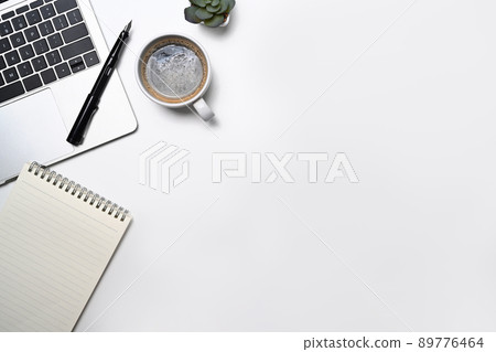 Minimal workplace with laptop computer, coffee cup, notepad and potted plant. Flat lay, Top view with copy space 89776464