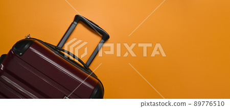 A suitcase on orange background with cop space. Preparing for the summer vacations 89776510