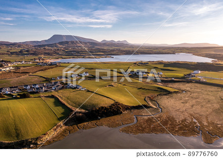 Aerial view of Dunfanaghy with the Muckish in background in County Donegal at sunset - Ireland 89776760