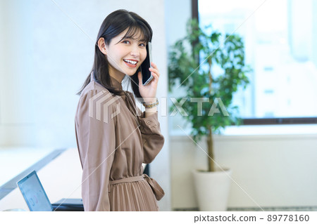 A young woman making a phone call with a smartphone 89778160