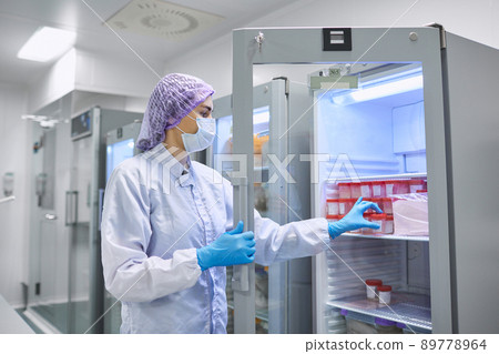 A girl scientist checks a sample for research A girl scientist checks a sample for research 89778964