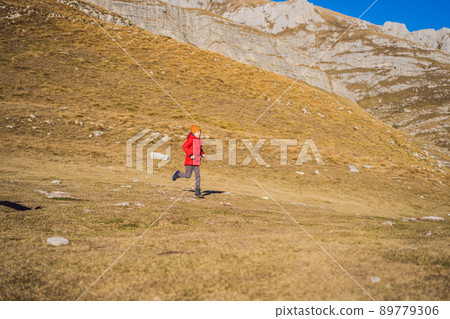Montenegro. Boy tourist on the background of Durmitor National Park. Saddle Pass. Alpine meadows. Mountain landscape. Travel around Montenegro concept 89779306