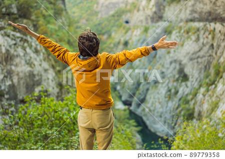 Man tourist in the background of Beautiful Canyon of Moraca river in winter, Montenegro or Crna Gora, Balkan, Europe 89779358