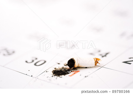 Extinguished cigarette about 31 days in the calendar closeup 89780166