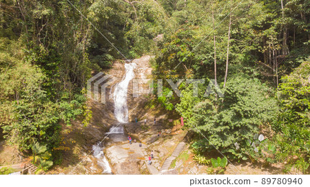 Waterfall in cameron highlands, malaysia. The water tumbles down the rocks into a small river. Refreshment for trekkers through the jungles of Malaysia. Rainforest creek between the dense jungle Waterfall in cameron highlands, malaysia. The water tumbles down the rocks into a small river. Refreshment for trekkers through the jungles of Malaysia. Rainforest creek between the dense jungle 89780940