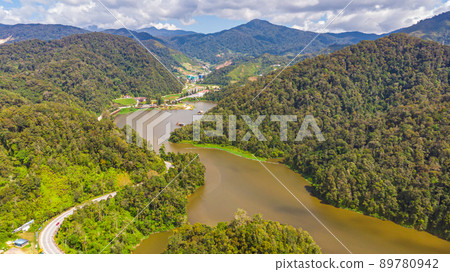 Aerial view over the Cameron Highlands, Malaysia from the sky. Aerial birds eye view over a artificial lake in the Malaysian Cameron highlands. Drone capture of the highland landscape with lake Aerial view over the Cameron Highlands, Malaysia from the sky. Aerial birds eye view over a artificial lake in the Malaysian Cameron highlands. Drone capture of the highland landscape with lake 89780942