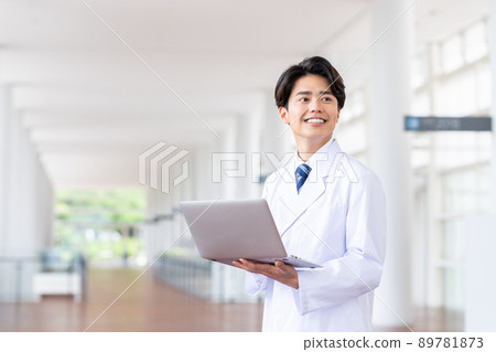 A young man in a lab coat with a computer 89781873