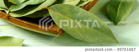Bay leaves panorama on a teal rustic wooden background, a close-up Bay leaves panorama on a teal rustic wooden background, a close-up 89781887