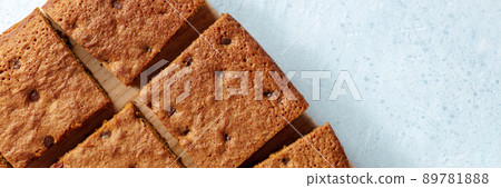 Blondie brownie dessert bars with chocolate chips panorama, shot from the top Blondie brownie dessert bars with chocolate chips panorama, shot from the top 89781888