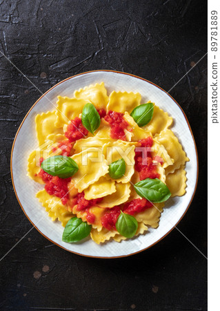 Ravioli with tomato sauce and basil. A plate of stuffed pasta, shot from above 89781889