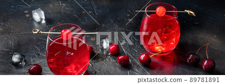 Cocktail with cherry and ice panorama, an aperitif with a garnish Cocktail with cherry and ice panorama, an aperitif with a garnish 89781891