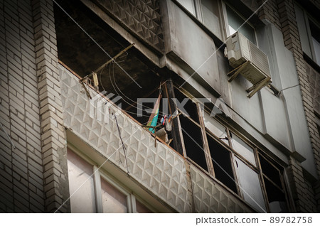 Ukrainian-Russian War 2022. A residential building in Mykolaiv that suffered from Russian army shelling. The balcony of an apartment building without glass. A burned apartment building. 89782758