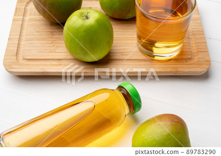 Fresh apple juice in bottles on gray background 89783290