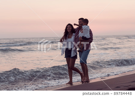 Happy young family have fun and live healthy lifestyle on beach. Selective focus  89784448