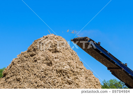 An industrial wood chipper at work roots grinding machine to become chip 89784984
