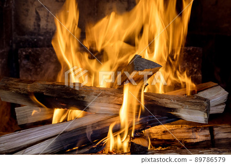 Home fire burning in brick fireplace Home fire burning in brick fireplace 89786579