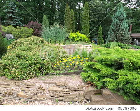 Beautiful autumn park landscape with flower beds. Floral Landscape. Garden Landscaping Design. 89787096