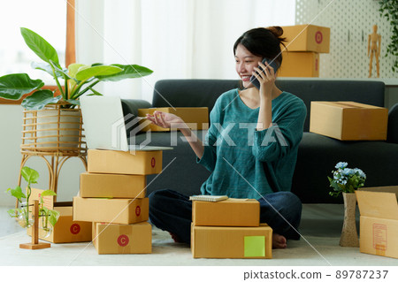 Asian small business owner working at home office. Business retail market and online sell marketing delivery, SME e-commerce concept. Asian small business owner working at home office. Business retail market and online sell marketing delivery, SME e-commerce concept. 89787237