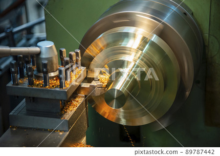 The lathe machine finish cutting the brass disk parts by lathe tools. 89787442