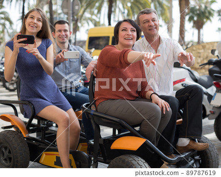 family of tourists enjoy a walk on the bike carriage 89787619