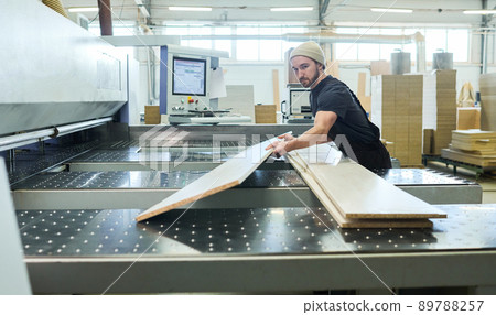 Manual worker working with wooden boards 89788257