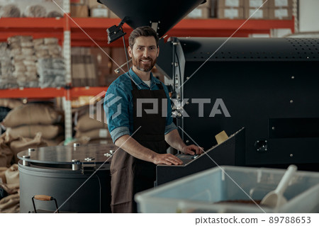 Business owner operating of coffee roasting machine on own small roasted factory 89788653