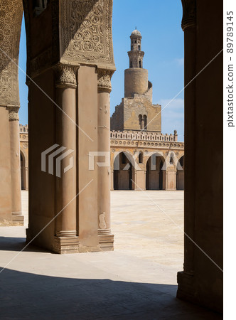 Minaret of Ibn Tulun public historical mosque framed decorated arch, Cairo, Egypt 89789145