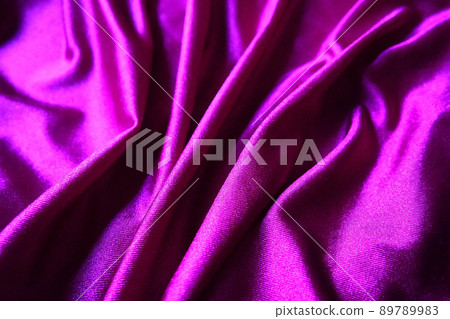 Velour fabric, similar to silk. Textiles in a folds and beautiful waves. Purple, pink, magenta shades on the drapery. Sewing material for evening dresses, furniture upholstery, curtains and interior Velour fabric, similar to silk. Textiles in a folds and beautiful waves. Purple, pink, magenta shades on the drapery. Sewing material for evening dresses, furniture upholstery, curtains and interior 89789983