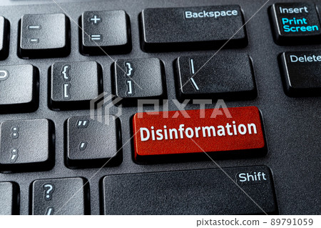 Disinformation red key on the black desktop keyboard. Warning message on the computer enter key. Disinformation red key on the black desktop keyboard. Warning message on the computer enter key. 89791059