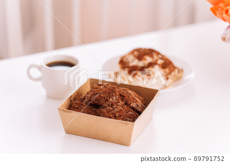 Two cakes with cup of coffee on white table Two cakes with cup of coffee on white table 89791752