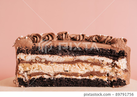 Piece of puff-chocolate cake against pink background Piece of puff-chocolate cake against pink background 89791756