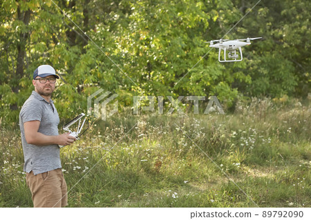 Man manages quadrocopters. Remote control for the drone in the hands of men. Unmanned aerial vehicle Man manages quadrocopters. Remote control for the drone in the hands of men. Unmanned aerial vehicle 89792090