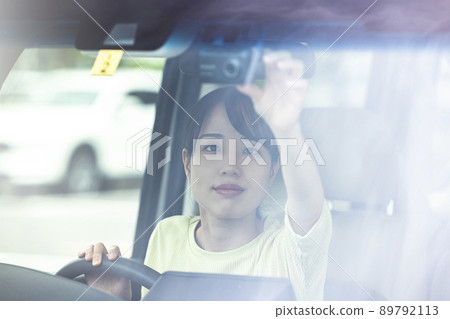 Woman operating a drive recorder Woman operating a drive recorder 89792113