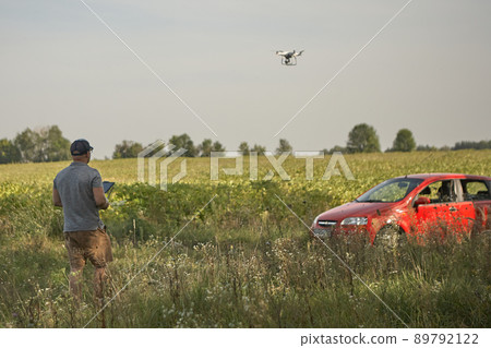 Man manages quadrocopters. Remote control for the drone in the hands of men. Unmanned aerial vehicle 89792122