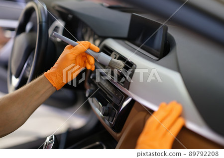 Brush cleaning of dust from car interior parts Brush cleaning of dust from car interior parts 89792208