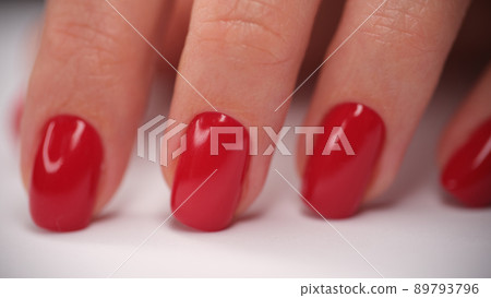 Female hand with perfect red glossy manicure Female hand with perfect red glossy manicure 89793796