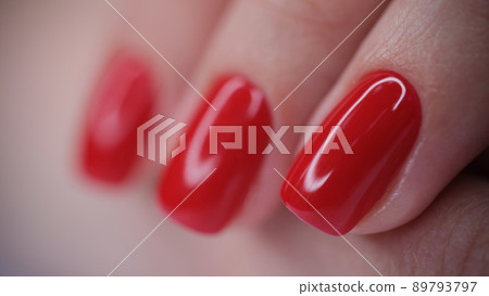 Female hand with red bright glossy varnish Female hand with red bright glossy varnish 89793797