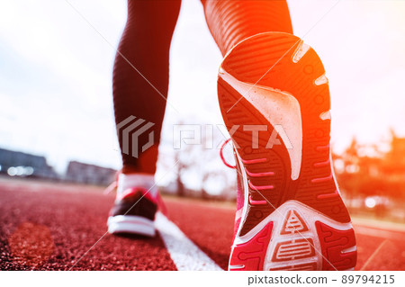 Sport running woman exercise. Runner feet running on road closeup on shoe. Run female workout exercise. Sport and healthy lifestyle. 89794215