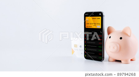 Mobile banking. Smartphone with internet online bank application. Piggy bank with debit card on white background. Save money business concept. Mobile banking. Smartphone with internet online bank application. Piggy bank with debit card on white background. Save money business concept. 89794268