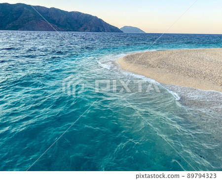 Coast. the sandy island in the center is washed by water. the beauty of the sea, holidays in hot countries, the beauty and tranquility of the sea breeze Coast. the sandy island in the center is washed by water. the beauty of the sea, holidays in hot countries, the beauty and tranquility of the sea breeze 89794323