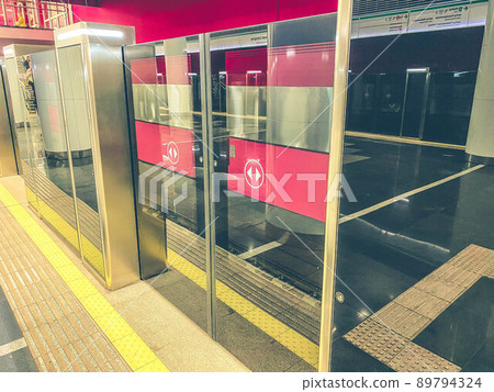 underground passage in the subway. The tunnel is protected by transparent plastic walls. safety of passengers from falling onto the train line underground passage in the subway. The tunnel is protected by transparent plastic walls. safety of passengers from falling onto the train line 89794324