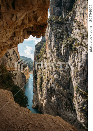 A path excavated in the rock allows to cross Congost de Mont-Rebei defile. Famous hiking trail in Spain. 89794605