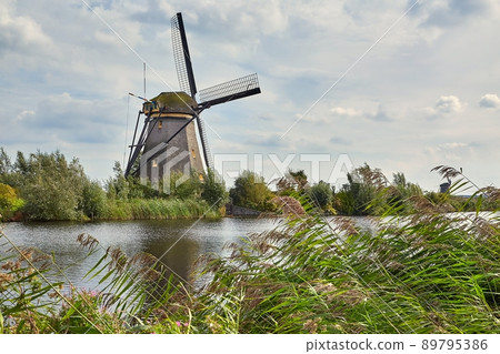 Windmill beside a canal Windmill beside a canal 89795386