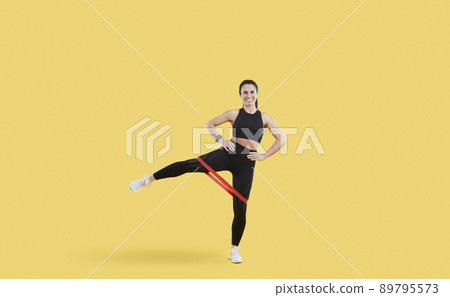 Positive strong sport fitness woman in stylish sportswear trains isolated on beige background. 89795573