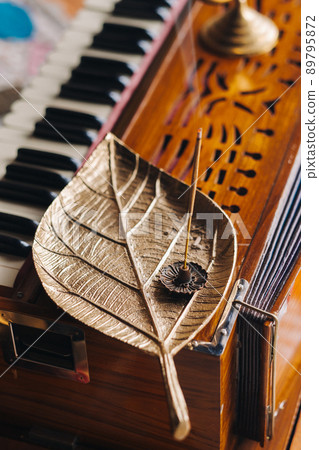 harmonium during the practice of kundalini yoga and the incense standing on it 89795872
