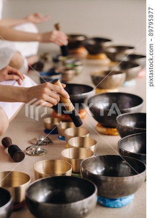 Close-up of a Tibetan singing bowl in your hands - Translation of mantras 89795877