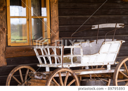 An empty antique carriage stands on a ranch in the wild West 89795893