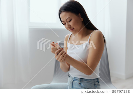 Tormented suffering from dislocation tanned beautiful young Asian woman hurting holding painful wrist at home interior living room. Injuries Poor health Illness concept. Cool offer Banner Tormented suffering from dislocation tanned beautiful young Asian woman hurting holding painful wrist at home interior living room. Injuries Poor health Illness concept. Cool offer Banner 89797128